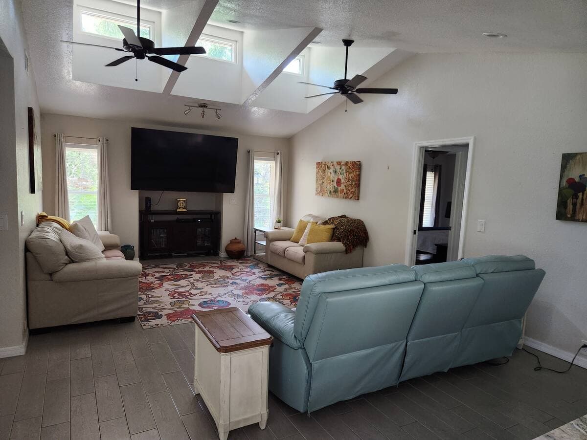 Open concept living room with 80 inch TV